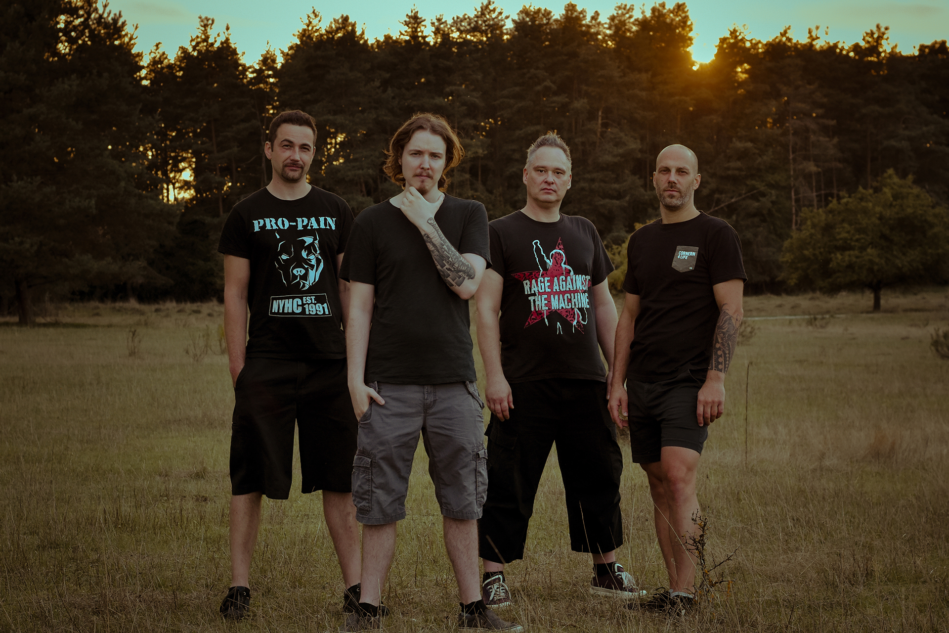 Karmament - The whole band on a field in front of a forest in Nuremberg